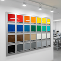 Wall of 20 powder-coated steel color sample panels with RAL codes in industrial paint lab